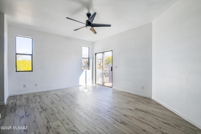 185 E Calle Zavala, Tucson, AZ 85704 - unfurnished room featuring a ceiling fan, plenty of natural light, wood finished floors, and baseboards