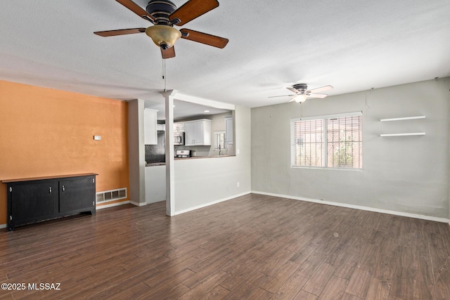 2113 N Belvedere Ave, Tucson, AZ 85712 - unfurnished living room featuring ceiling fan, dark wood-style floors, baseboards, and a textured ceiling
