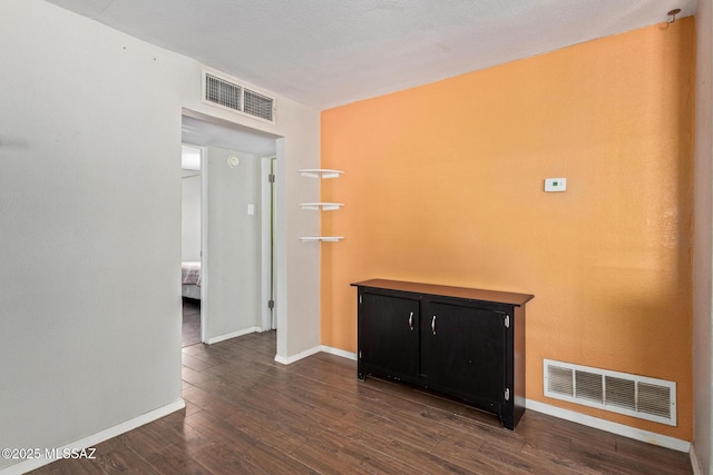 2113 N Belvedere Ave, Tucson, AZ 85712 - empty room featuring dark wood-type flooring and baseboards