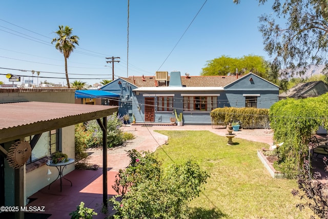 1912 E Water St, Tucson, AZ 85719 - rear view of property with a yard and a patio