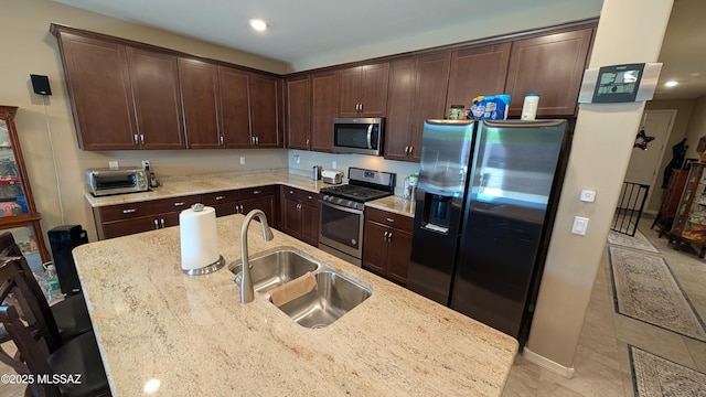10218 S Hickory Wood Way, Vail, AZ 85641 - kitchen featuring stainless steel appliances, a sink, dark brown cabinets, light stone countertops, and recessed lighting