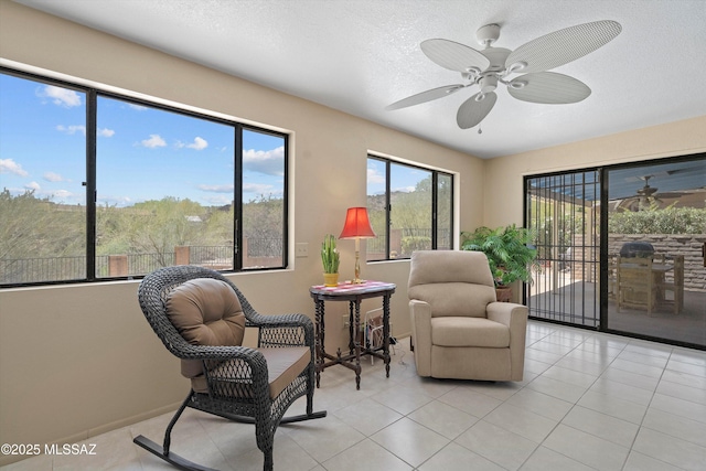 7302 E Rocky Creek Pl, Tucson, AZ 85750 - sitting room with a ceiling fan, light tile patterned flooring, a textured ceiling, and baseboards