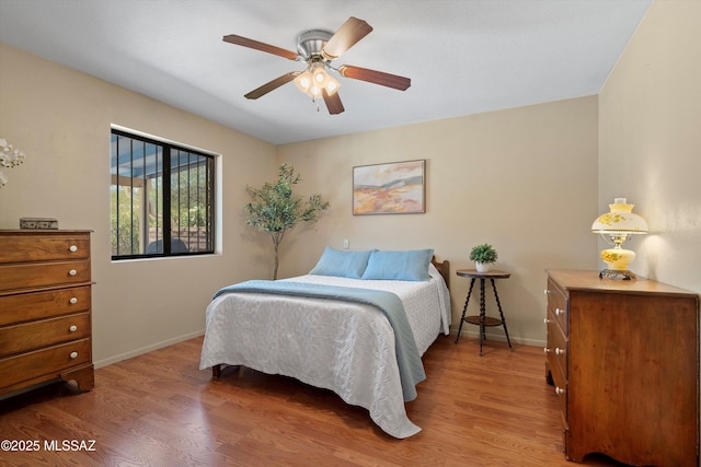7302 E Rocky Creek Pl, Tucson, AZ 85750 - bedroom featuring wood finished floors, baseboards, and ceiling fan