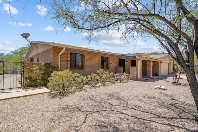 7302 E Rocky Creek Pl, Tucson, AZ 85750 - view of front of home featuring a gate, brick siding, and a garage