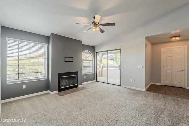 101 S Players Club Dr Unit 11204, Tucson, AZ 85745 - unfurnished living room featuring a ceiling fan, carpet floors, a fireplace with flush hearth, baseboards, and lofted ceiling
