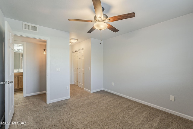 101 S Players Club Dr Unit 11204, Tucson, AZ 85745 - unfurnished bedroom featuring light carpet, a sink, baseboards, and a closet