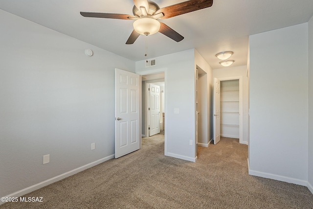 101 S Players Club Dr Unit 11204, Tucson, AZ 85745 - unfurnished bedroom with light carpet, baseboards, and ceiling fan
