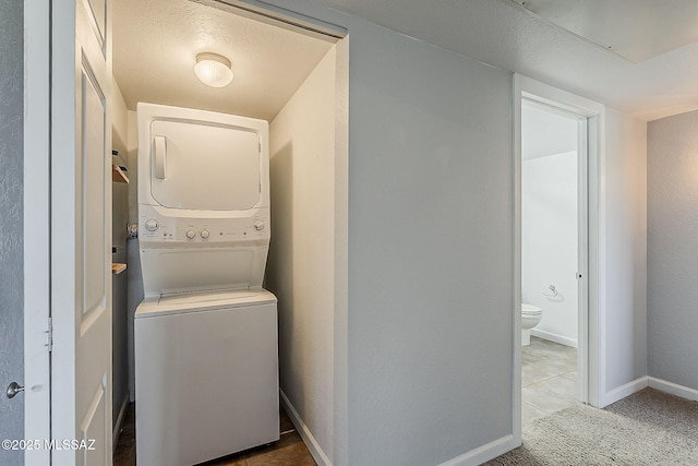 101 S Players Club Dr Unit 11204, Tucson, AZ 85745 - laundry room with stacked washing machine and dryer and baseboards