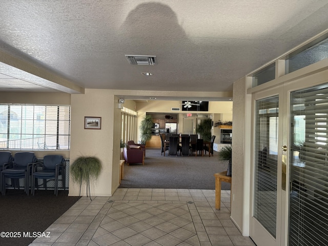 101 S Players Club Dr Unit 11204, Tucson, AZ 85745 - corridor with carpet flooring, a textured ceiling, tile patterned flooring, and baseboards
