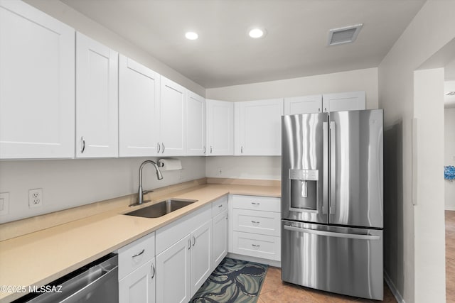 2917 E Malvern St, Tucson, AZ 85716 - kitchen featuring stainless steel appliances, a sink, white cabinets, light countertops, and recessed lighting