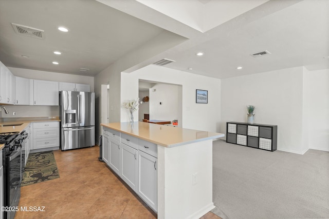 2917 E Malvern St, Tucson, AZ 85716 - kitchen featuring stainless steel fridge, gas stove, light countertops, a sink, and recessed lighting