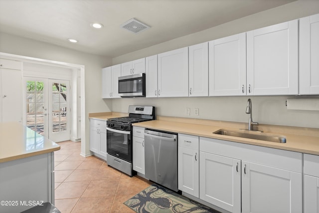2917 E Malvern St, Tucson, AZ 85716 - kitchen featuring appliances with stainless steel finishes, a sink, recessed lighting, light countertops, and light tile patterned flooring