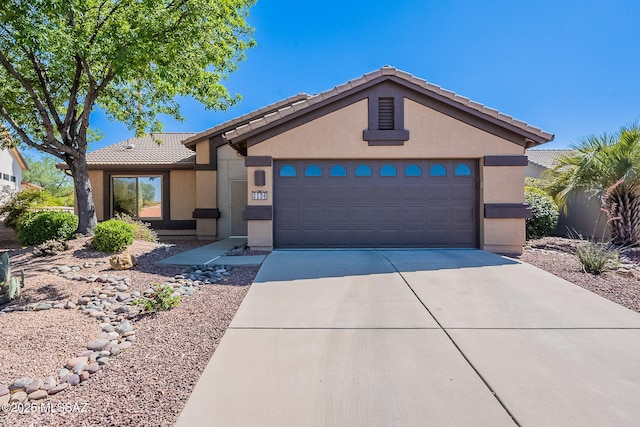 2136 E Desert Fox Dr, Green Valley, AZ 85614 - single story home featuring concrete driveway, a tile roof, stucco siding, and a garage