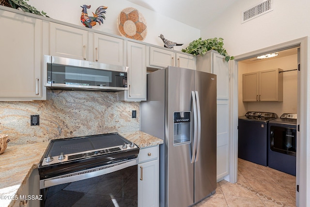 2136 E Desert Fox Dr, Green Valley, AZ 85614 - kitchen featuring appliances with stainless steel finishes, separate washer and dryer, tasteful backsplash, and light tile patterned floors