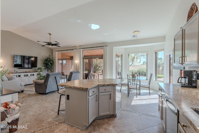 2136 E Desert Fox Dr, Green Valley, AZ 85614 - kitchen featuring dishwashing machine, plenty of natural light, open floor plan, a breakfast bar, and vaulted ceiling