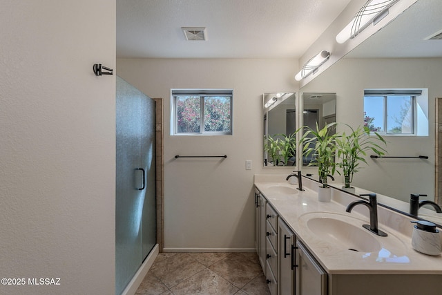 2136 E Desert Fox Dr, Green Valley, AZ 85614 - full bathroom featuring double vanity, baseboards, a stall shower, and tile patterned flooring