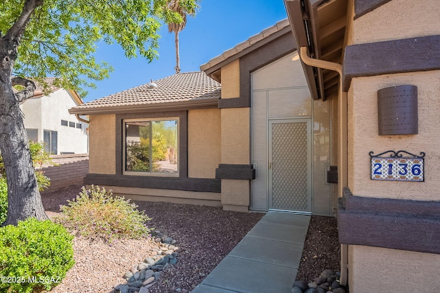 2136 E Desert Fox Dr, Green Valley, AZ 85614 - doorway to property with a tile roof and stucco siding