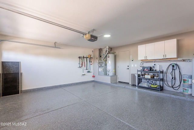 2136 E Desert Fox Dr, Green Valley, AZ 85614 - garage featuring gas water heater, a garage door opener, baseboards, and recessed lighting