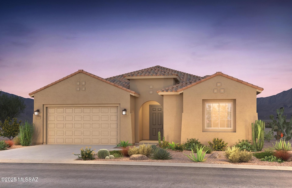 1091 E Pyrope Pl, Tucson, AZ 85755 - mediterranean / spanish-style home featuring a garage, stucco siding, concrete driveway, and a tile roof
