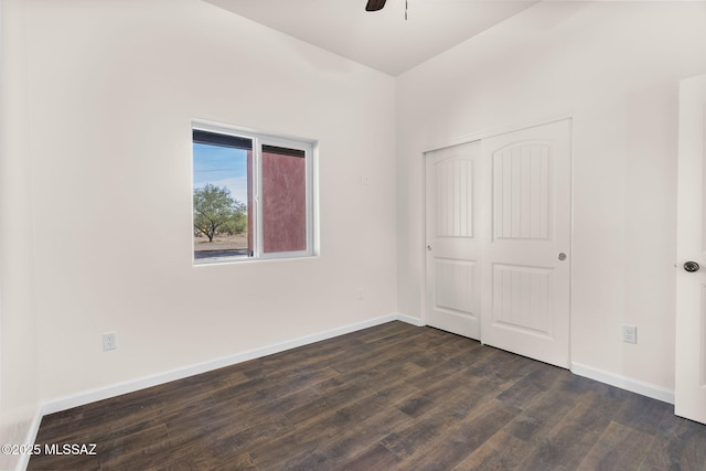 1801 Saltillo Ct, Rio Rico, AZ 85648 - unfurnished bedroom with dark wood finished floors, baseboards, a closet, and ceiling fan