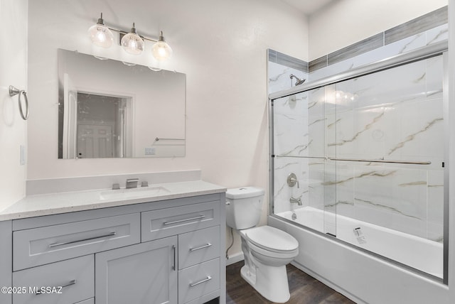 1801 Saltillo Ct, Rio Rico, AZ 85648 - bathroom with vanity, toilet, wood finished floors, and shower / bath combination with glass door