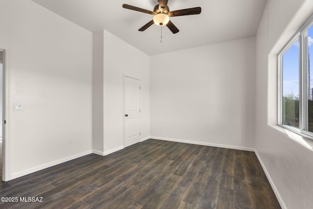 1801 Saltillo Ct, Rio Rico, AZ 85648 - empty room featuring a ceiling fan, dark wood-style floors, and baseboards
