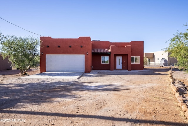 1801 Saltillo Ct, Rio Rico, AZ 85648 - southwest-style home featuring an attached garage, driveway, and stucco siding