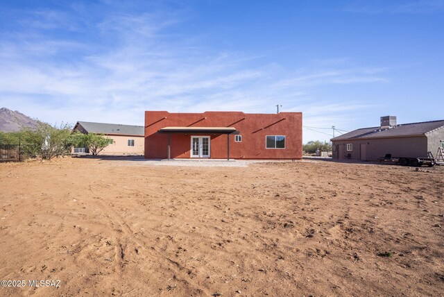 1801 Saltillo Ct, Rio Rico, AZ 85648 - rear view of house with french doors, central AC unit, and stucco siding
