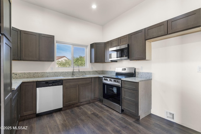 1801 Saltillo Ct, Rio Rico, AZ 85648 - kitchen featuring stainless steel appliances, a sink, dark wood-type flooring, light stone counters, and recessed lighting