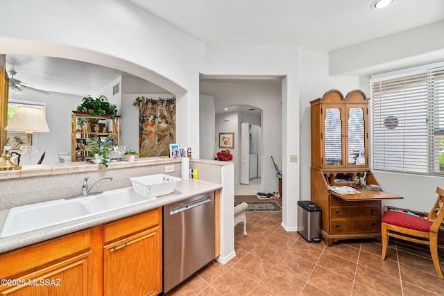 7466 E Placita Del Misterio, Tucson, AZ 85715 - kitchen featuring dishwasher, a sink, arched walkways, light tile patterned flooring, and ceiling fan