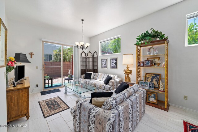 7466 E Placita Del Misterio, Tucson, AZ 85715 - living area featuring a chandelier, baseboards, and light tile patterned flooring