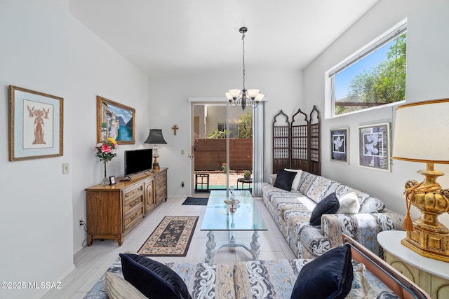 7466 E Placita Del Misterio, Tucson, AZ 85715 - living room featuring a chandelier and baseboards