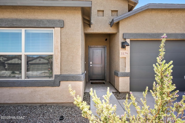 3579 N Kellen Canyon Ct, Tucson, AZ 85745 - doorway to property featuring stucco siding and an attached garage
