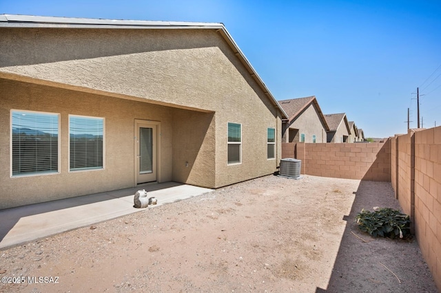 3579 N Kellen Canyon Ct, Tucson, AZ 85745 - rear view of house featuring stucco siding, a fenced backyard, a patio, and central AC unit