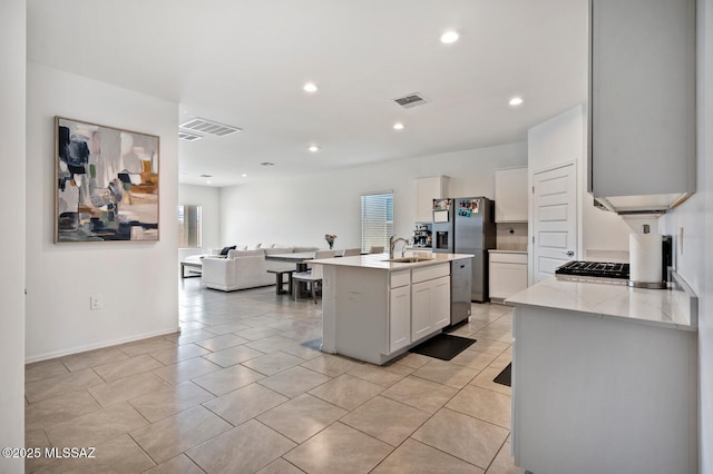 3579 N Kellen Canyon Ct, Tucson, AZ 85745 - kitchen featuring a sink, stainless steel appliances, open floor plan, white cabinets, and an island with sink