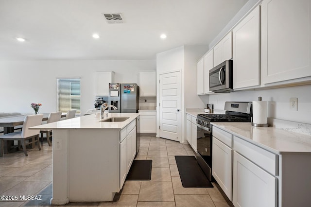 3579 N Kellen Canyon Ct, Tucson, AZ 85745 - kitchen with appliances with stainless steel finishes, a sink, light tile patterned flooring, white cabinets, and recessed lighting