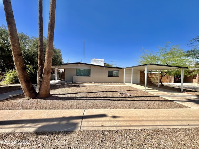 5541 E Mabel St, Tucson, AZ 85712 - view of front of property featuring driveway, an attached carport, and a chimney