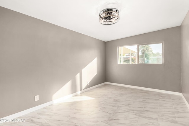 5541 E Mabel St, Tucson, AZ 85712 - spare room featuring light marble finish floors and baseboards