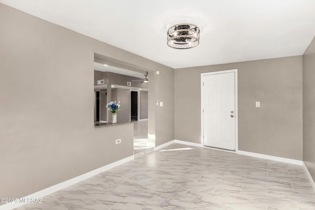 5541 E Mabel St, Tucson, AZ 85712 - spare room with light marble finish flooring and ceiling fan