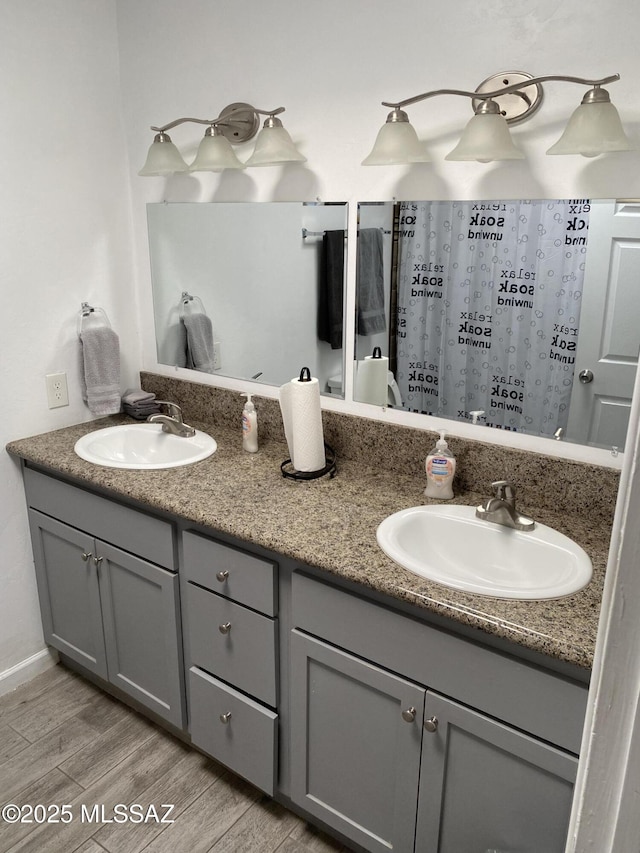 3533 N Palmer Dr, Tucson, AZ 85716 - full bathroom with double vanity and wood finished floors