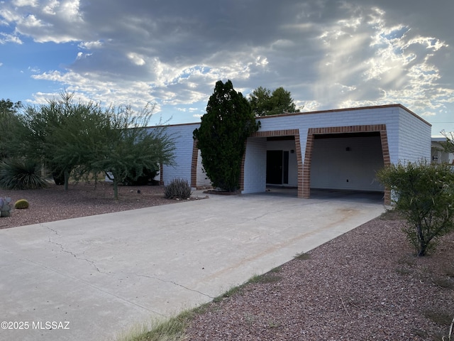 3533 N Palmer Dr, Tucson, AZ 85716 - view of front of home with driveway, an attached garage, and brick siding