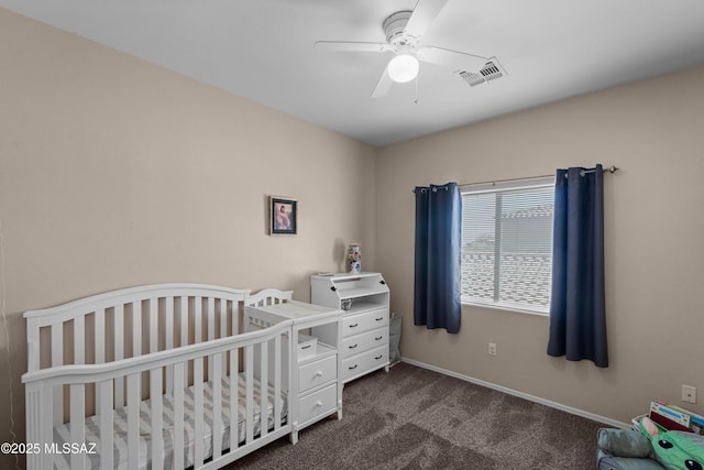77 N Mail Station Ln, Sahuarita, AZ 85629 - bedroom with dark carpet, a crib, ceiling fan, and baseboards