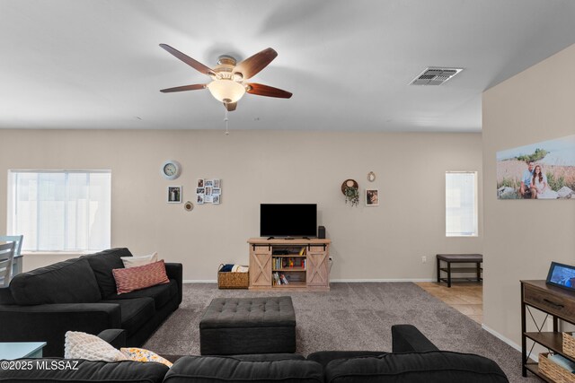 77 N Mail Station Ln, Sahuarita, AZ 85629 - carpeted living room featuring a ceiling fan and baseboards
