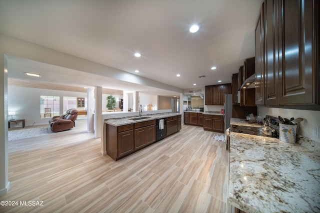 5617 N Camino Del Conde, Tucson, AZ 85718 - kitchen featuring a sink, open floor plan, under cabinet range hood, dishwasher, and light stone counters