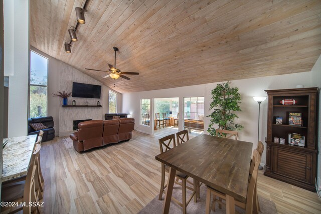 5617 N Camino Del Conde, Tucson, AZ 85718 - dining space featuring track lighting, wooden ceiling, a ceiling fan, a fireplace, and light wood-style floors