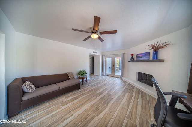5617 N Camino Del Conde, Tucson, AZ 85718 - living area featuring french doors, wood finished floors, ceiling fan, and baseboards
