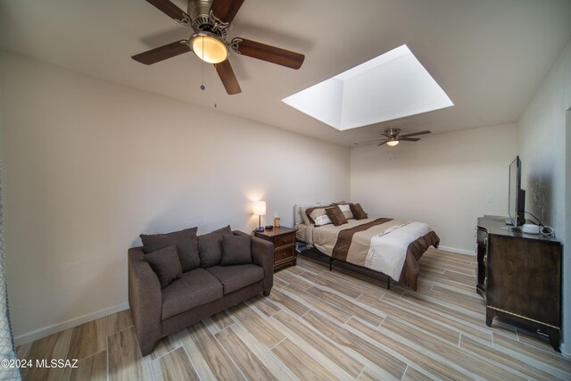 5617 N Camino Del Conde, Tucson, AZ 85718 - bedroom featuring a skylight, light wood-style floors, baseboards, and a ceiling fan