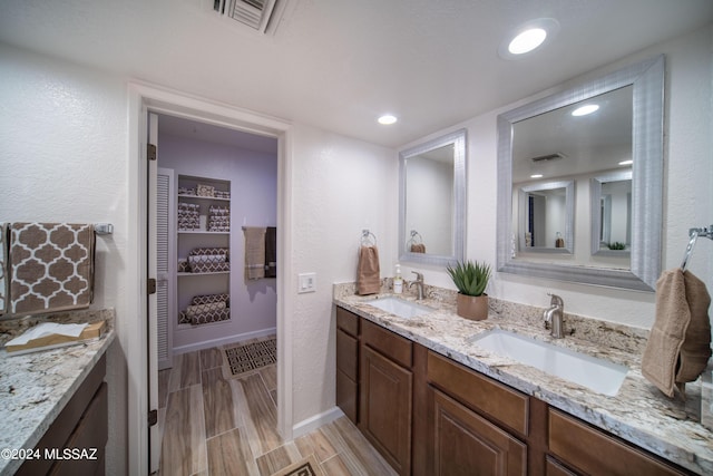 5617 N Camino Del Conde, Tucson, AZ 85718 - full bath featuring double vanity, baseboards, a closet, and wood finished floors