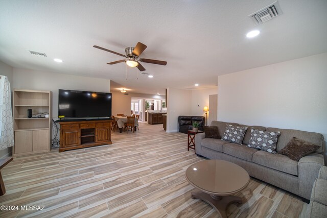 5617 N Camino Del Conde, Tucson, AZ 85718 - living room featuring a ceiling fan, light wood finished floors, baseboards, and recessed lighting
