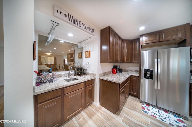 5617 N Camino Del Conde, Tucson, AZ 85718 - kitchen with stainless steel refrigerator with ice dispenser, a sink, light stone countertops, light wood finished floors, and recessed lighting